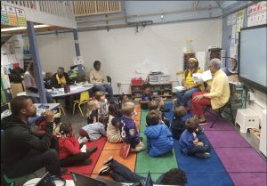 students listening to an adult reading